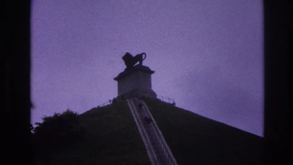 The 1967 Paris footage moves closer to the hillside monument, with the stairway rising toward the lion statue and railings.