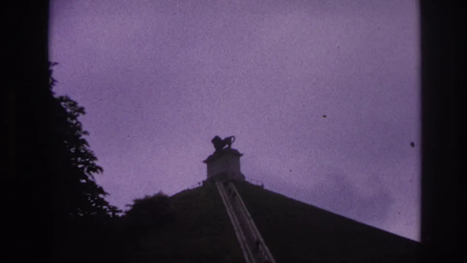 Final 1967 Paris frame shows the lion statue smaller in the composition above the hill and staircase at dusk.