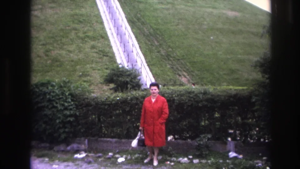 In the final frame, the woman faces the camera near the hedge, holding a white handbag in a Paris outdoor setting.