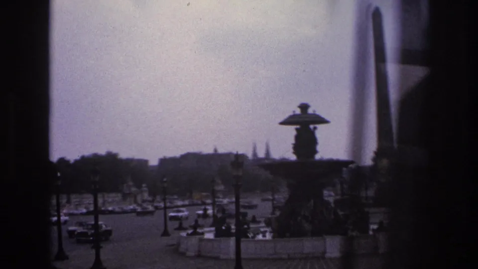 1967 Paris roundabout view with an ornate fountain or monument in the foreground and cars moving below.