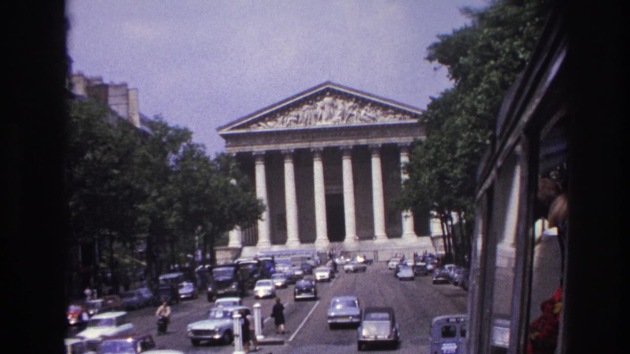 1967 Paris frame showing the Panthéon ahead, with mid-century cars, pedestrians, and the side of the filming vehicle visible.