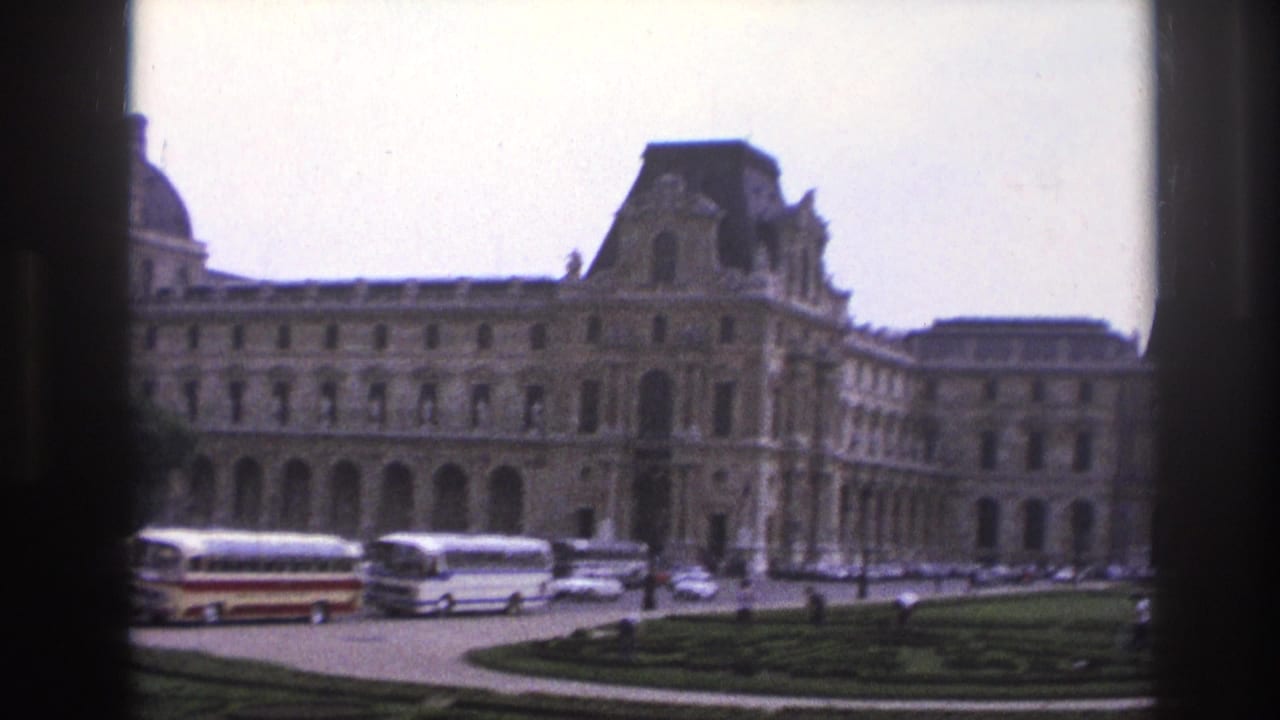 Louvre facade with buses, cars, lawns, arched windows, and dark vertical framing.