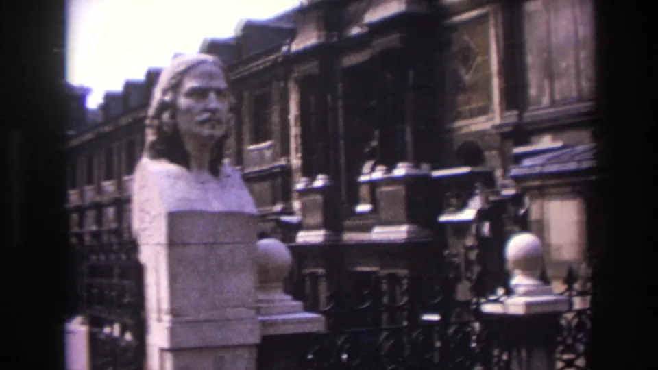 1967 Paris frame with the marble bust filling the foreground and carved architectural details receding along the street or courtyard.