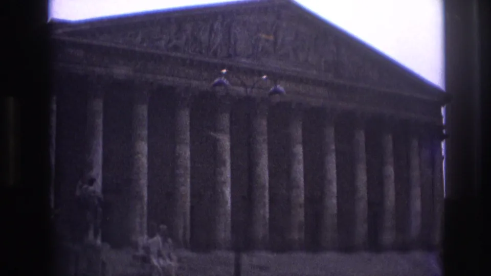 1967 Paris home-movie view of a large columned facade, partly obscured by the bus or window edge.