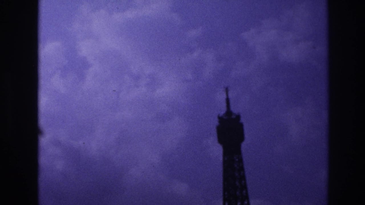 Tower top near the right side against a cloudy purple sky.