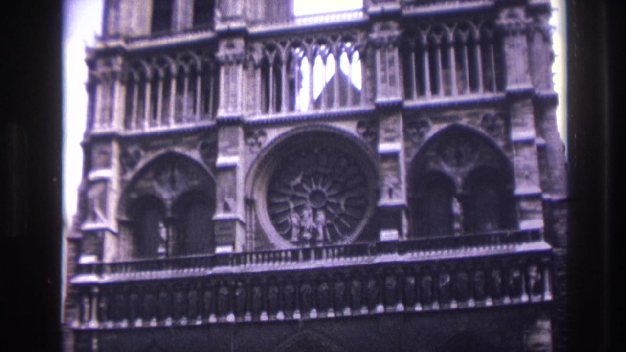 Notre-Dame facade with rose window, arches, and upper stone tracery.