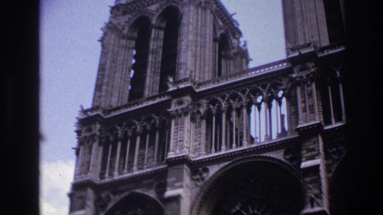 Notre-Dame Cathedral facade cropped tightly with arches, stone columns, and tower sections.