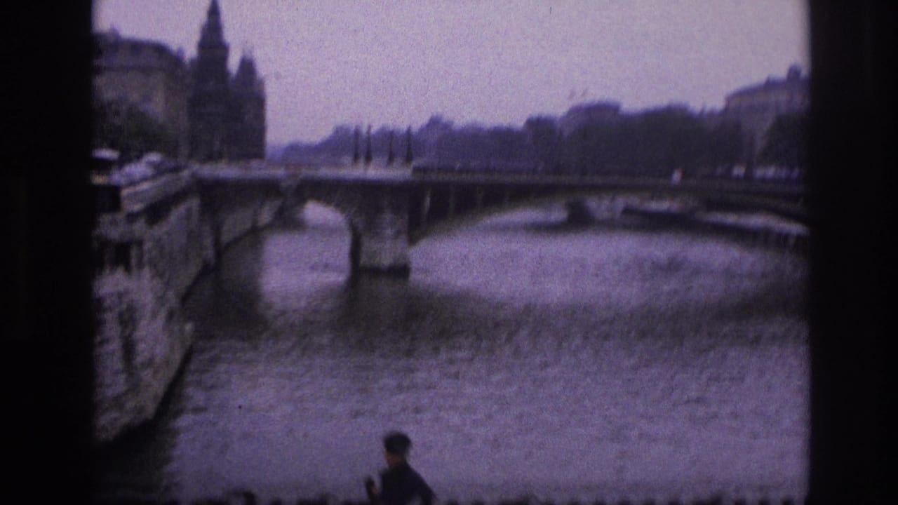 River bridge seen through dark film borders with a small figure near the lower edge.