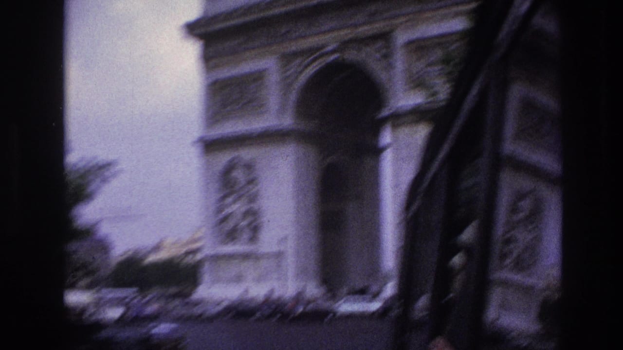 Blurred side view of the Arc de Triomphe with a dark vertical frame at center.