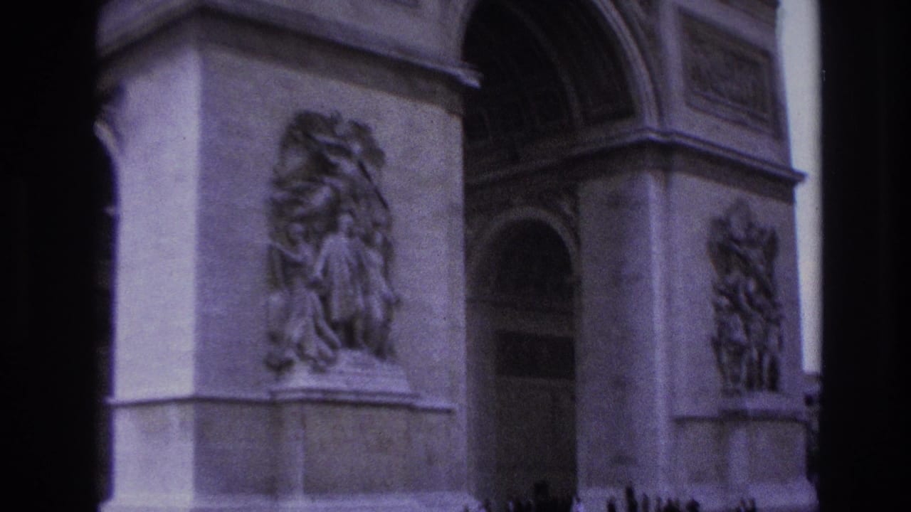 Close view of Arc de Triomphe relief panels and arch openings with a dark center border.