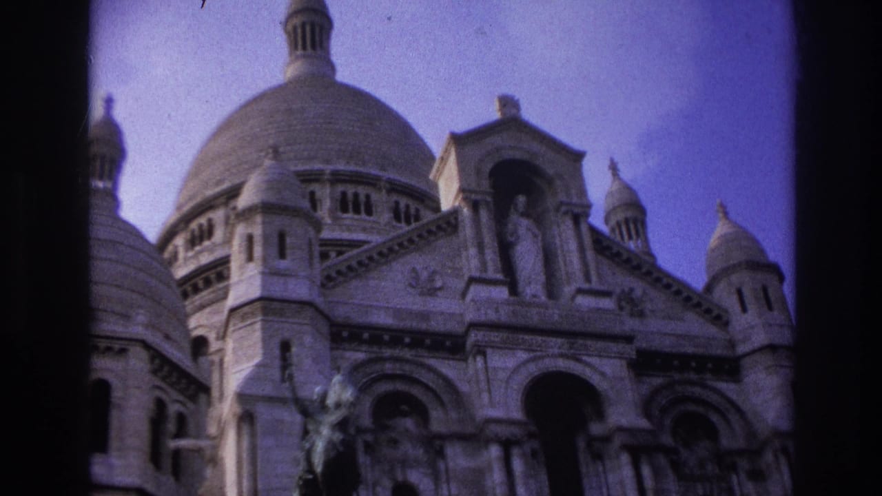 1967 Paris 8mm frame showing Sacre-Coeur Basilica from below, with domes, entrance arches, and a saint statue visible.