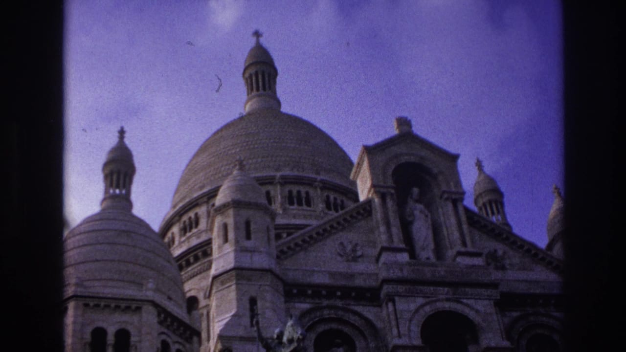 1967 Paris frame of Sacre-Coeur Basilica, showing the domed roofline, stone carving, and statue above the main entrance.