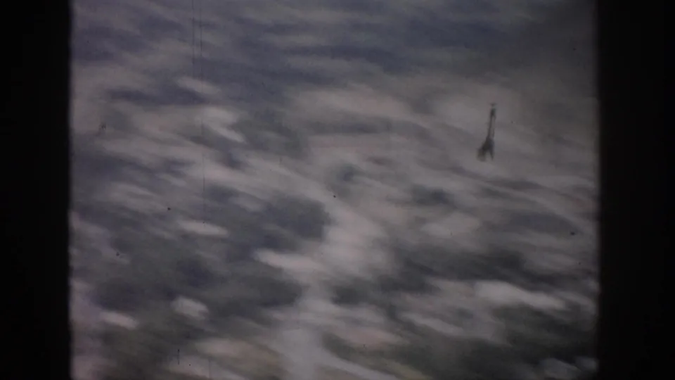 Motion-blurred 1959 Colorado 8mm aerial frame with softened roads, trees, and open valley terrain.