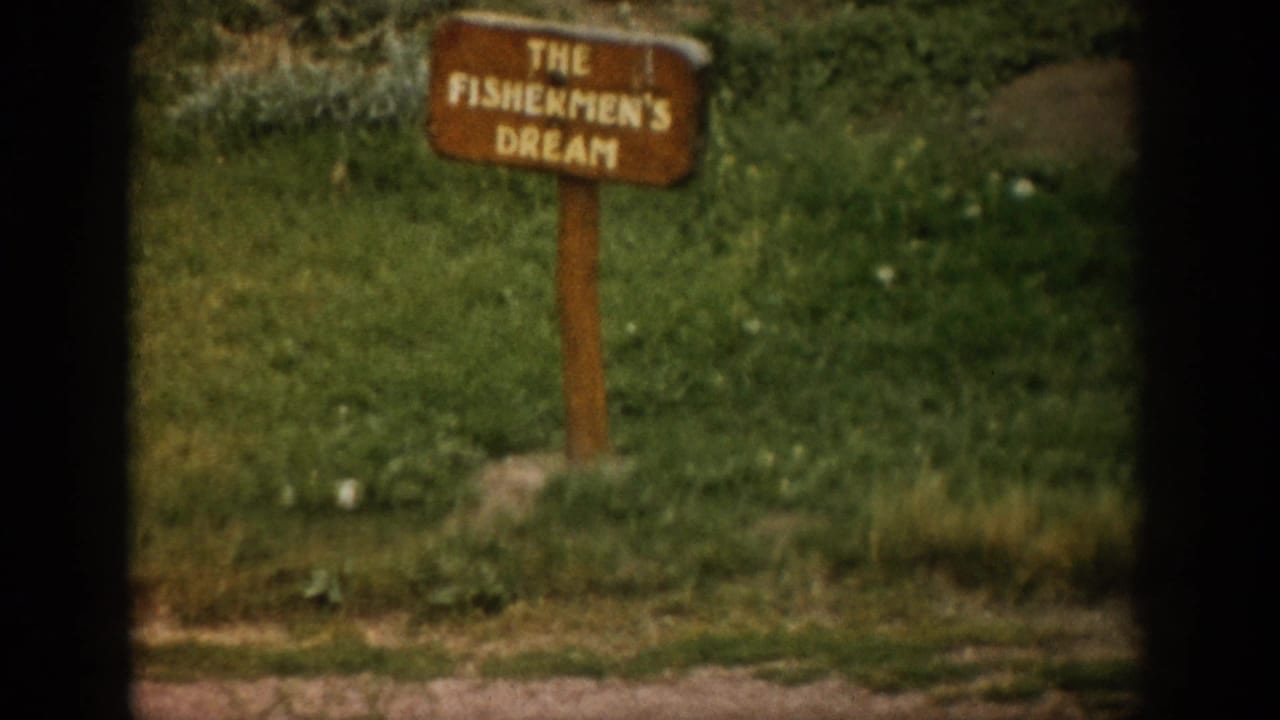 1959 Colorado 8mm frame showing a wooden roadside sign in grass reading The Fishermen's Dream.
