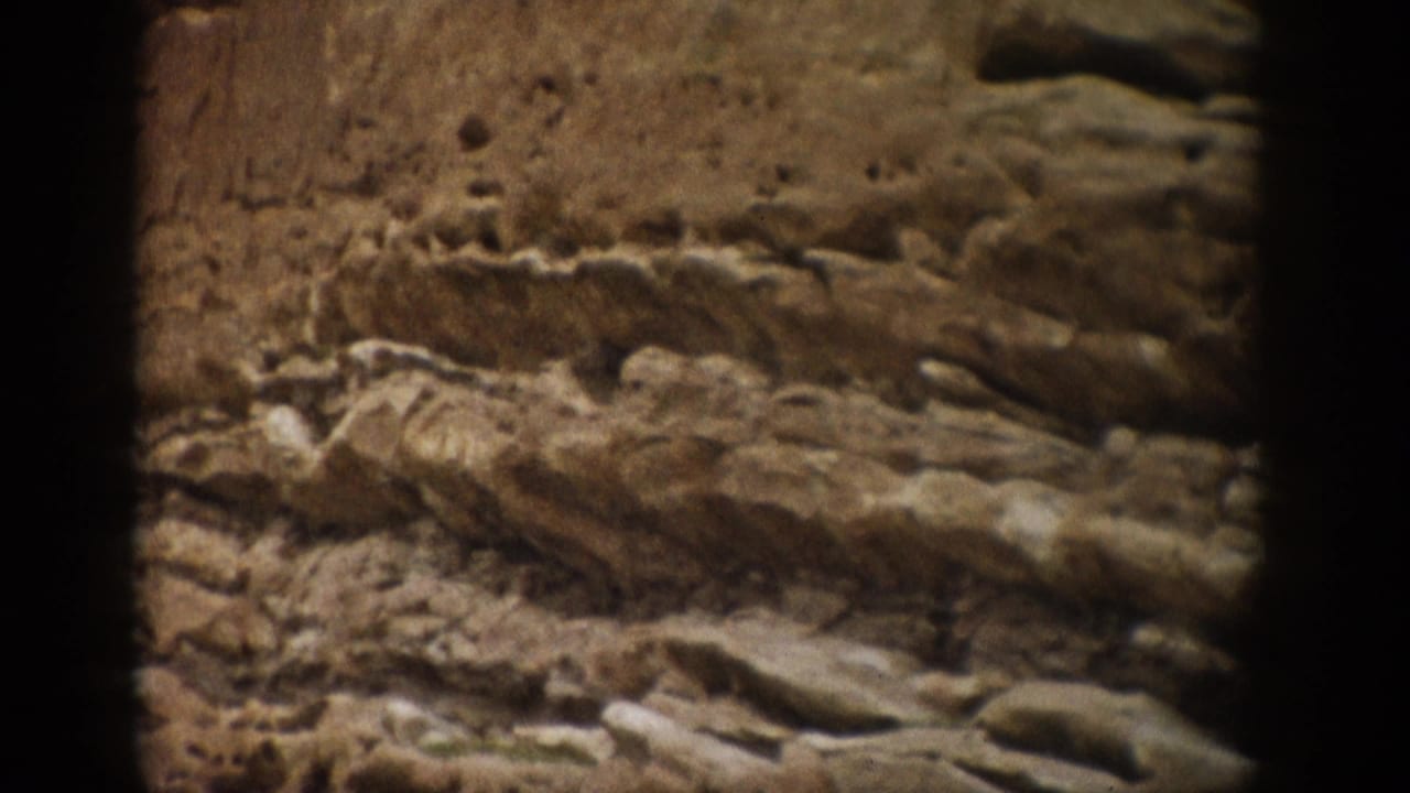 Similar close view of stratified sandstone with rough horizontal layers and darker frame edges.