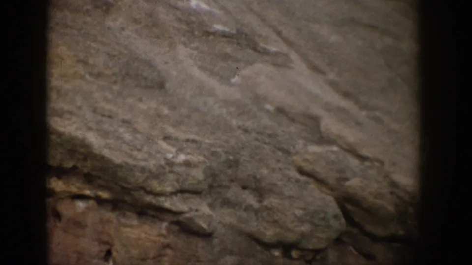 1959 Colorado 8mm frame showing soft-focus ridges and layered stone during a close landscape pan.