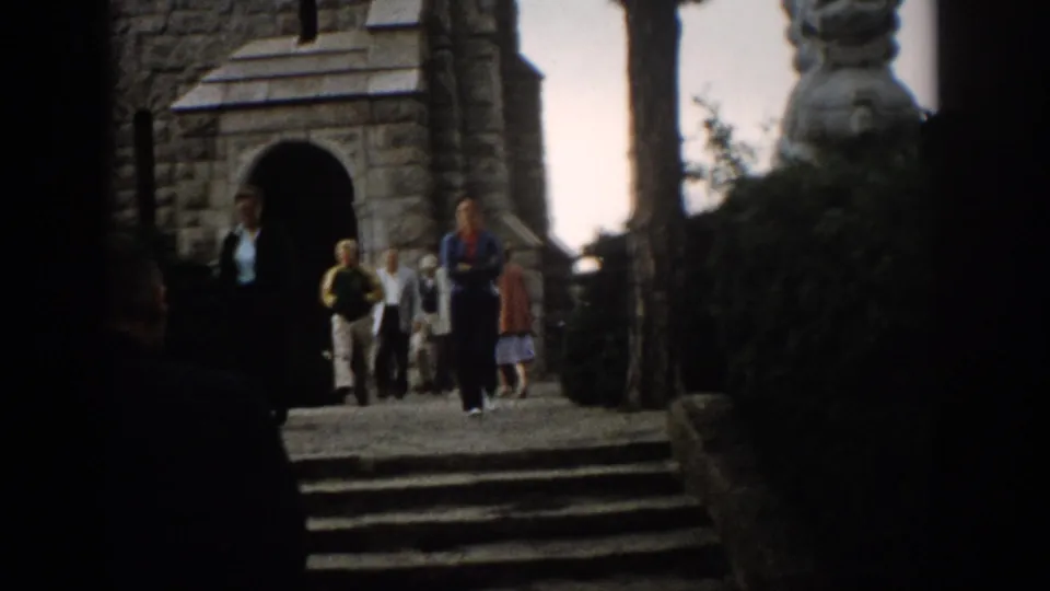 1959 Colorado travel footage showing tourists at stone steps beside an arched structure and carved stone figure.