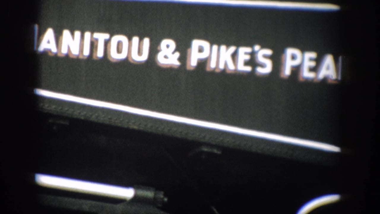 1959 Colorado 8mm close-up of white Manitou & Pike's Peak railway lettering on a black train side panel.