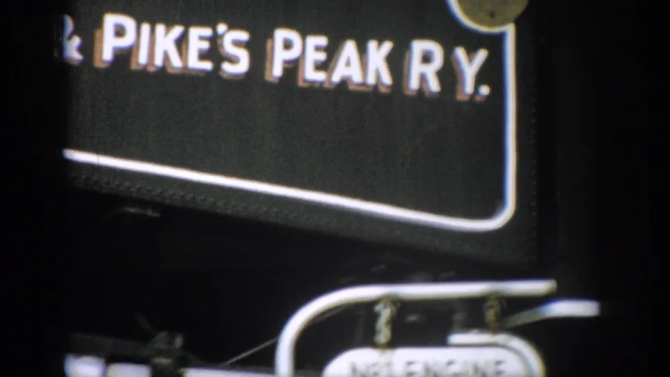 Close 8mm frame of Pike's Peak Ry. lettering on the black engine side, with the No.1 Engine plate partly visible below.
