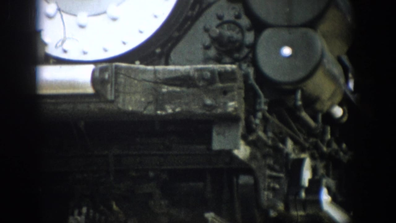 1959 Colorado 8mm frame showing close steam locomotive hardware with rivets, rods, and weathered metal surfaces.