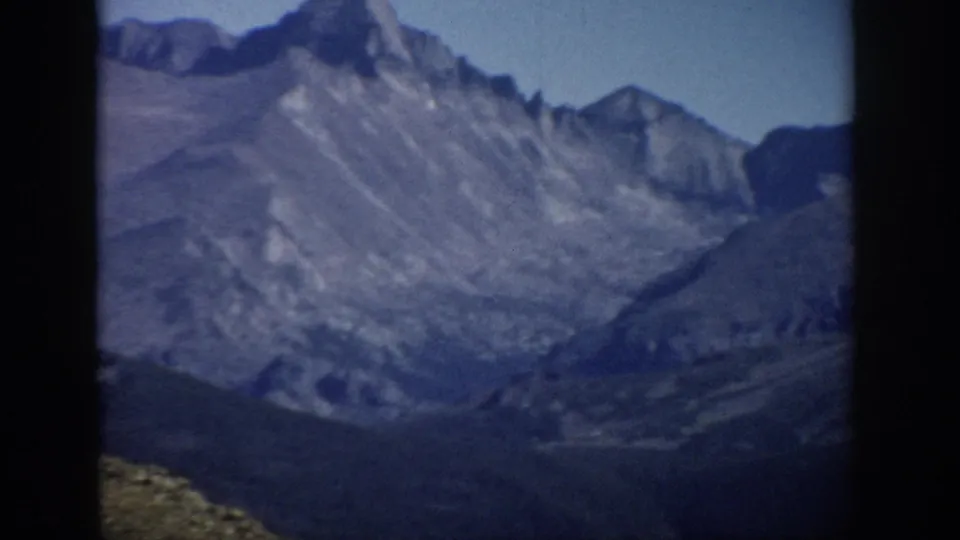 A soft-focus Colorado mountain view appears at the end of the 1959 home-movie clip.