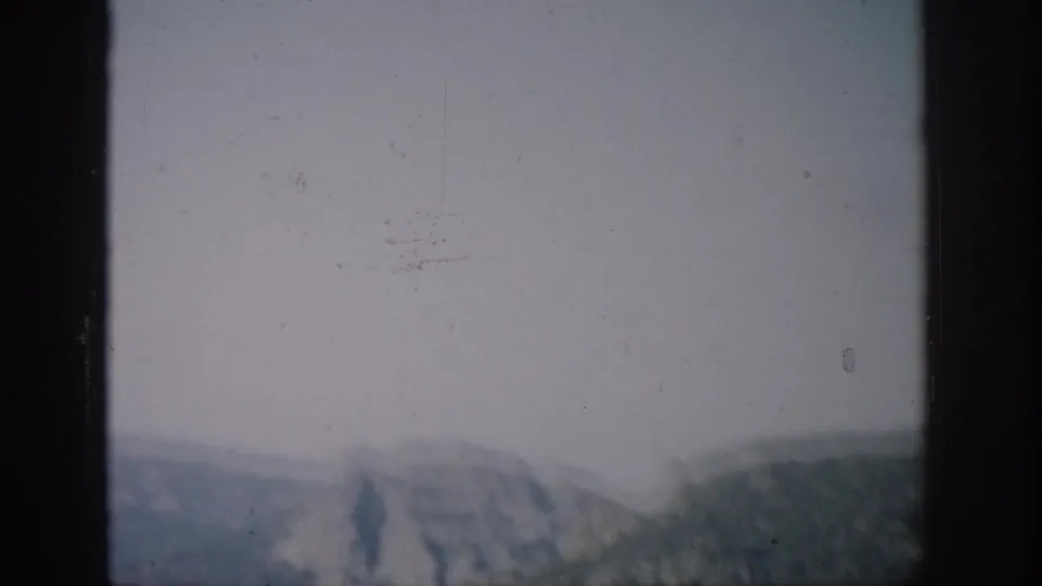 The final frame shows hazy Colorado ridges and forested slopes seen through the side of a helicopter window.
