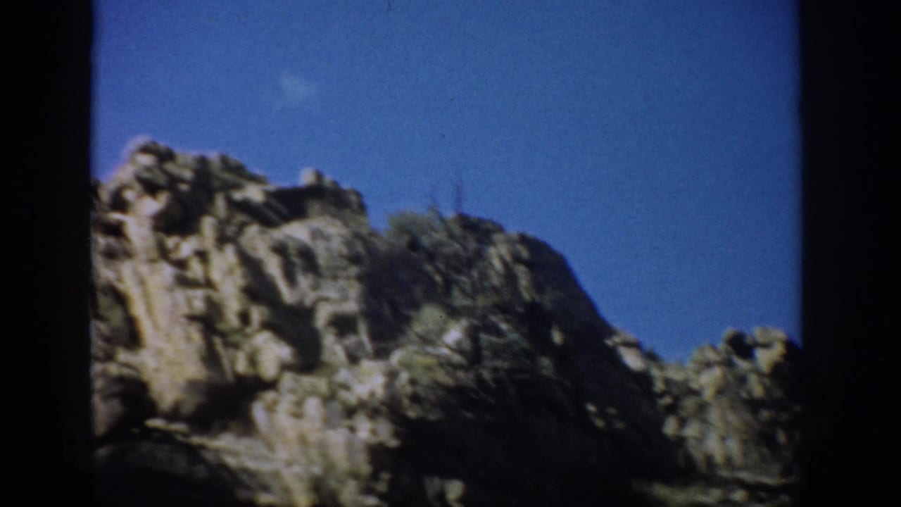 Jagged rock outcrop against a clear blue sky.