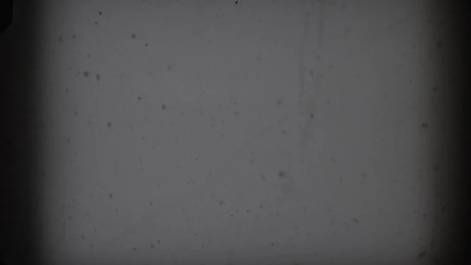 1959 Florida 8mm frame showing blank gray exposure with visible dust, grain, darkened edges, and no identifiable subject.