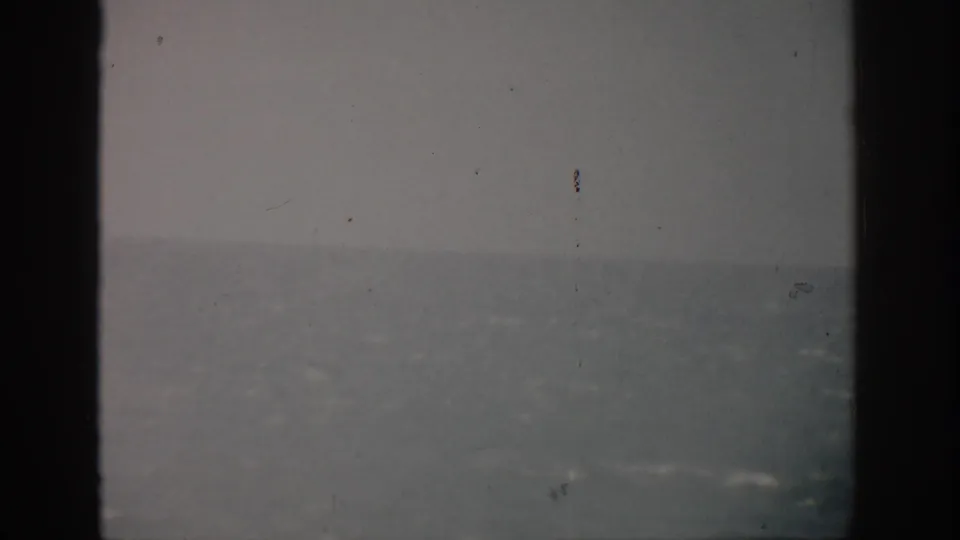 Faded 1959 Florida ocean view on 8mm film, with a hazy horizon and no clearly identifiable person in this frame.