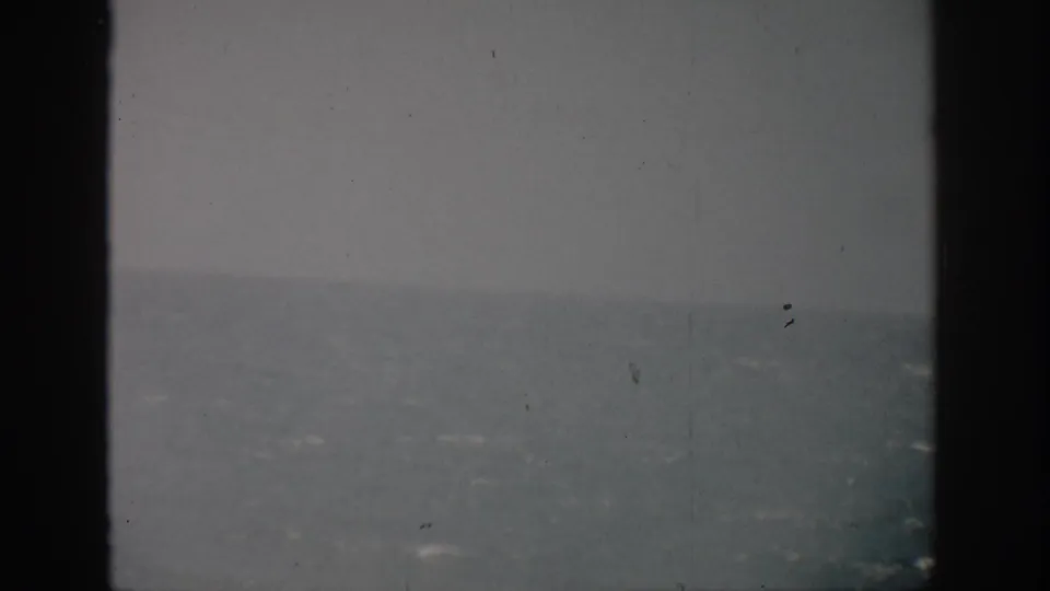 A muted 1959 Florida ocean view with gray sky, rough water, and a heavy dark vertical border dividing the frame.