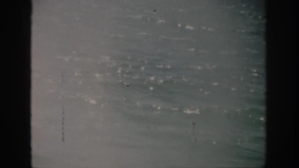 1959 Florida 8mm view of rippling ocean water under soft, overcast light.