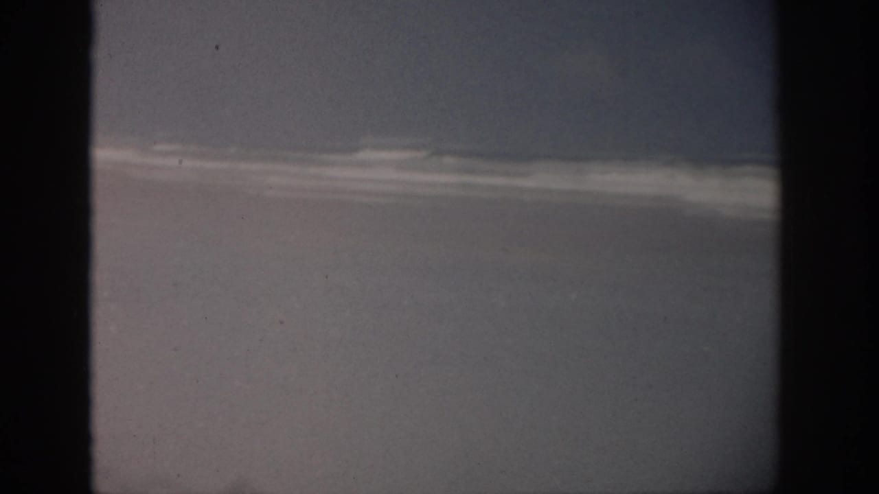 Soft, dark 8mm frame with a pale horizontal band and little visible action.