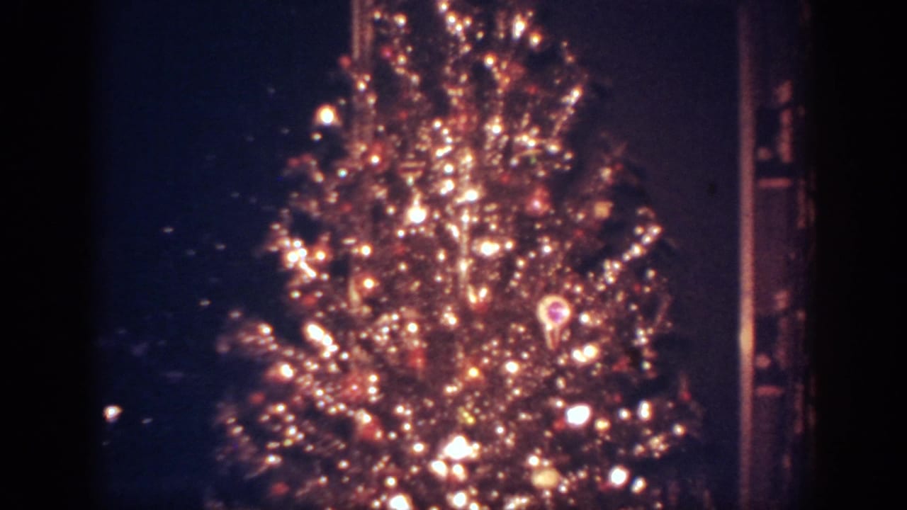 Rotating Christmas tree with bright lights and ornaments.