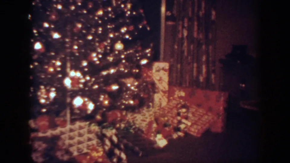 1962 Blainsport, Pennsylvania frame with the Christmas tree shifted right, showing lights, ornaments, gifts, and curtains.