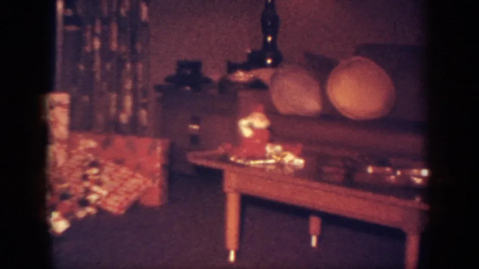 1962 Blainsport home interior showing a Santa decoration on a coffee table with gifts and sofa nearby.