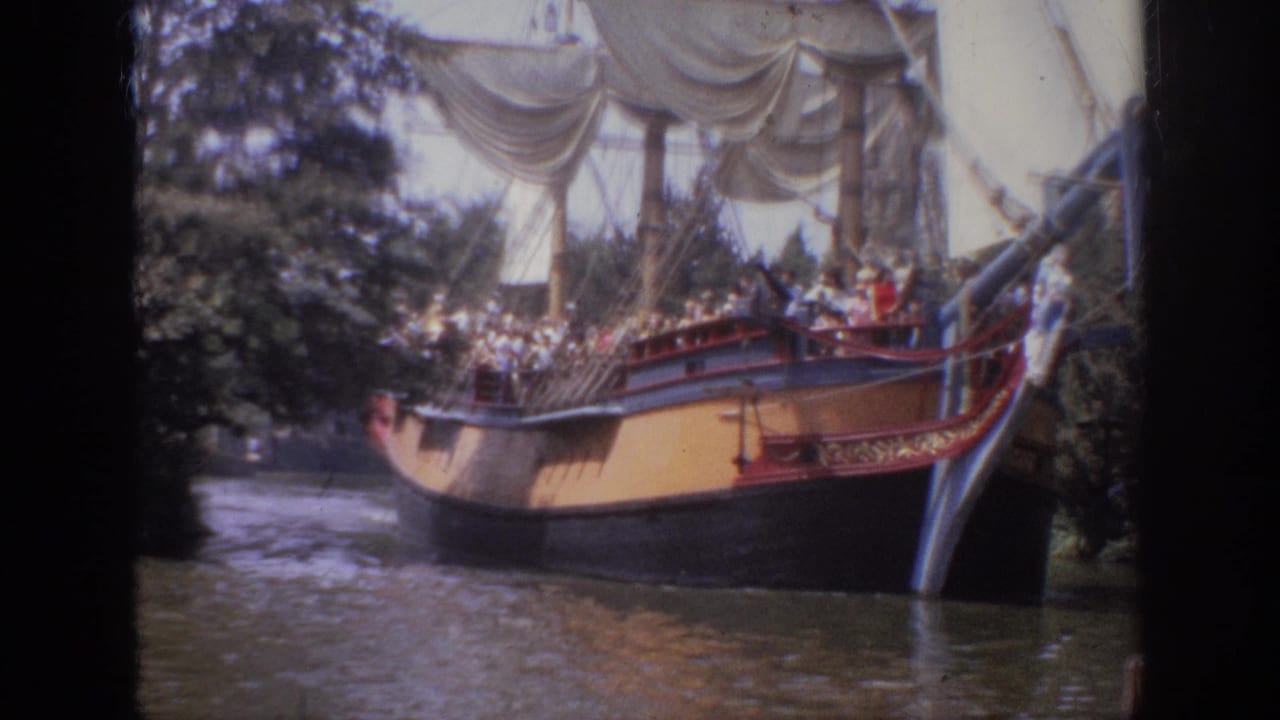 Sailing-ship attraction viewed from the side with visitors on deck.