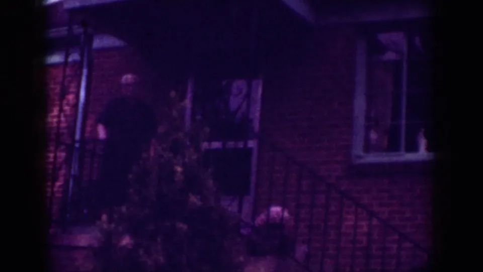 Final frame shows the older man still on the brick porch near a small evergreen, with the house window and railing visible.