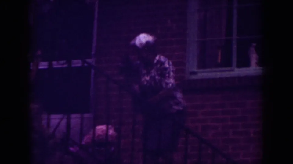 The final 1962 Raleigh frame shows a woman near the brick house porch with a dog partly visible below.