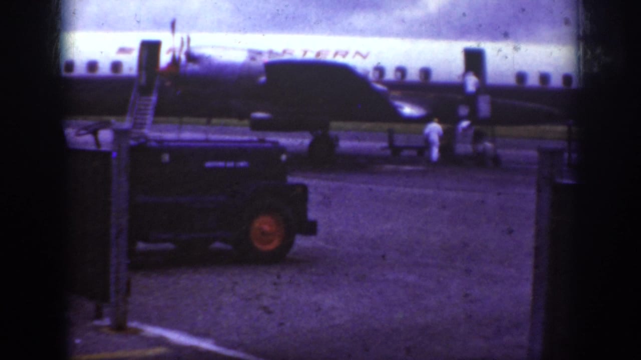 Western Airlines aircraft with stairs at the door and ground crew near the right side of the frame.