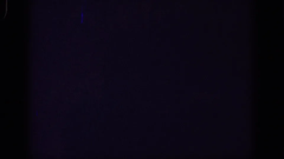 Very dark 8mm frame in the Yorba Linda home-movie clip, showing faint exposure, blue tint, grain, and gate-edge marks.
