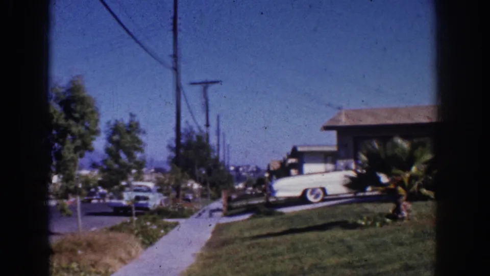 A Yorba Linda residential street view shows sidewalk, utility poles, parked cars, lawn, and part of the ranch-style house.