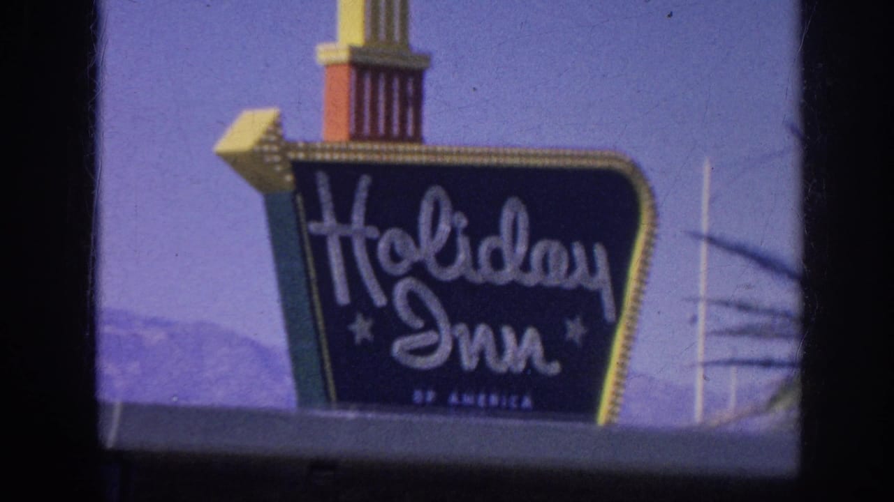 Holiday Inn roadside sign against a purple sky with film border visible.