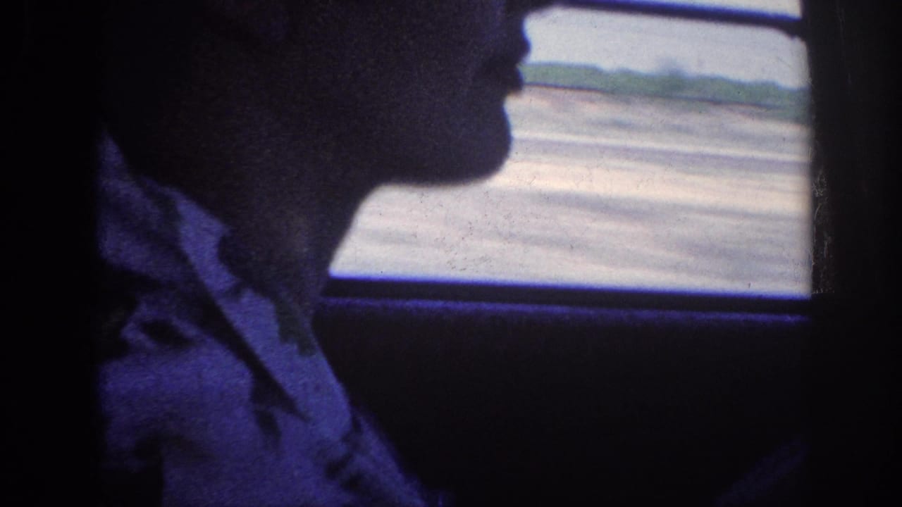 Profile silhouette of a man looking toward a car window, dark interior, strong blue color cast, 8mm film grain.
