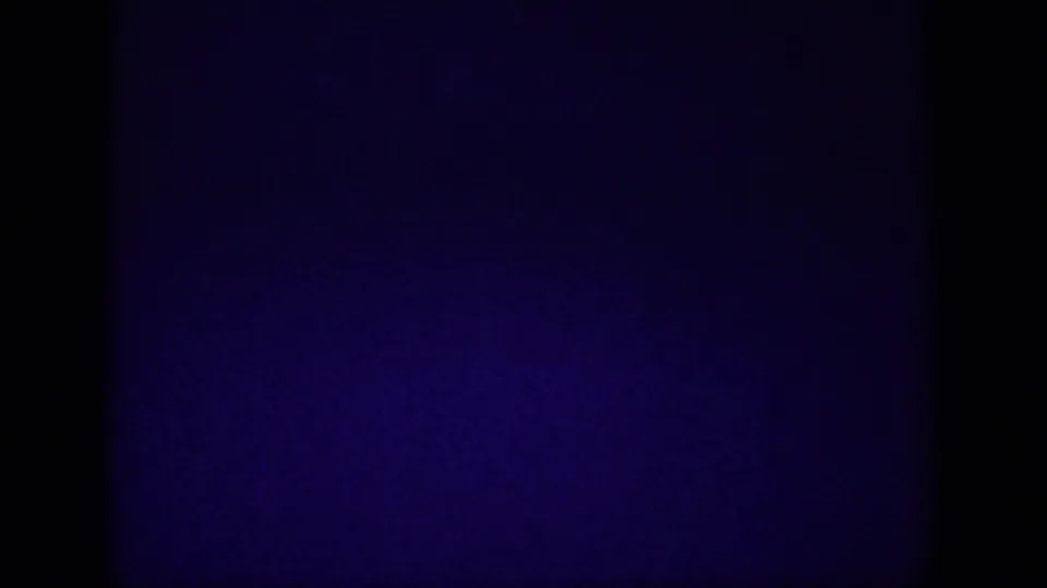 Black transition frame from an 8mm home-movie reel, likely a cut or film gap between the highway and hillside sequences.