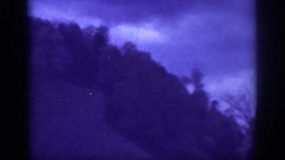 Continuation of handheld 8mm hillside shot, likely near Memphis, Tennessee, circa 1963, with pronounced blue-purple dye degradation throughout.