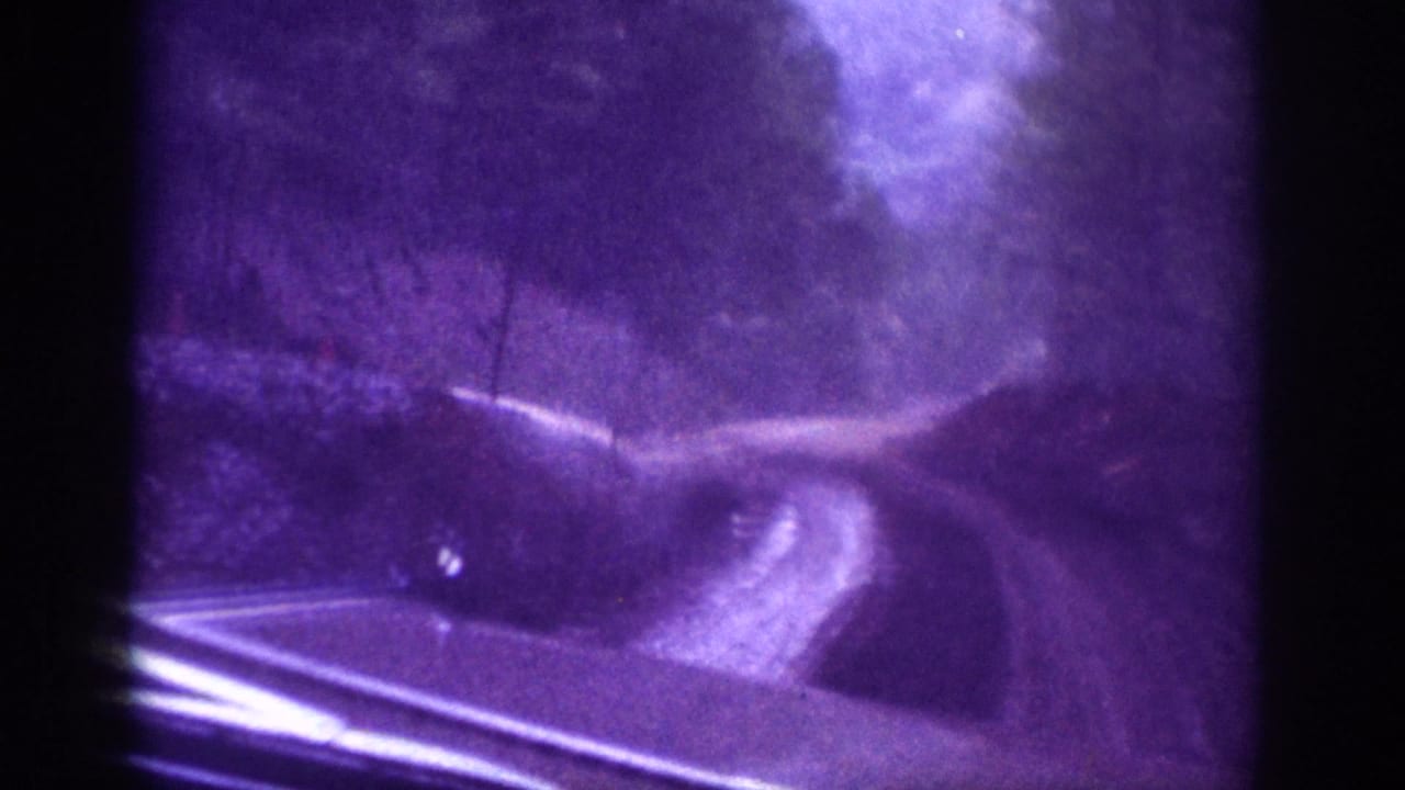 8mm home movie POV from inside a vehicle on a winding dirt road through a wooded area, Tennessee region, circa 1963.