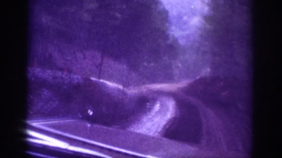 8mm home movie POV from inside a vehicle on a winding dirt road through a wooded area, Tennessee region, circa 1963.