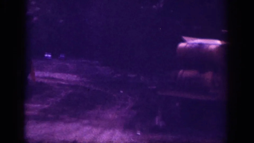 Final frame of a 1963 8mm clip from Memphis, Tennessee; heavy purple color cast and grain persist; an unidentified object and faint blue light point are the only distinguishable elements.