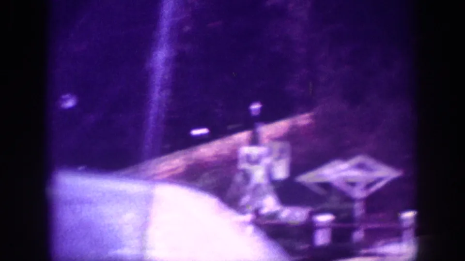 8mm in-car shot showing dashboard details and a diamond-shaped emblem or road sign during a 1963 Memphis nighttime road trip.
