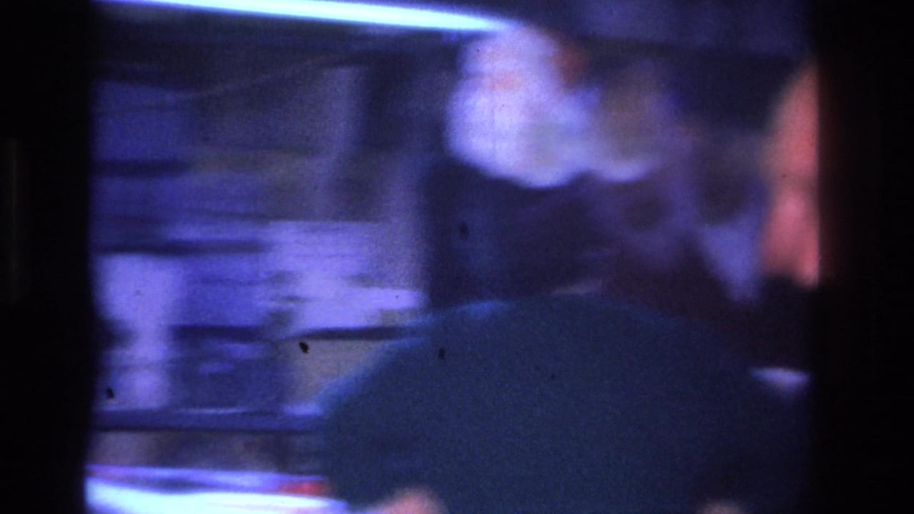 Camera pan from a 1966 Hoboken home movie showing severe motion blur and blue-purple color shift characteristic of 8mm panning under artificial indoor light.